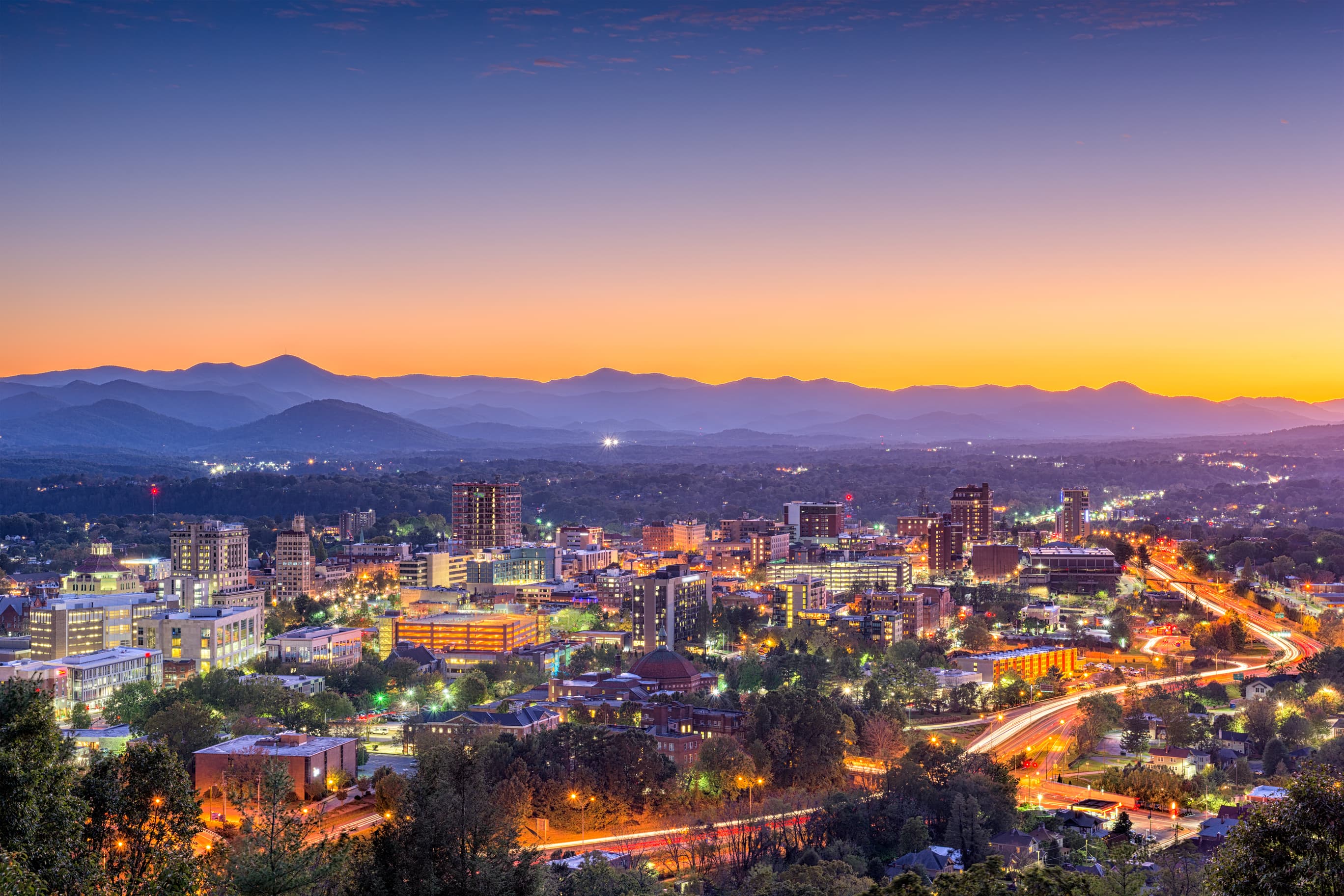 asheville skyline at dusk, mountains in background