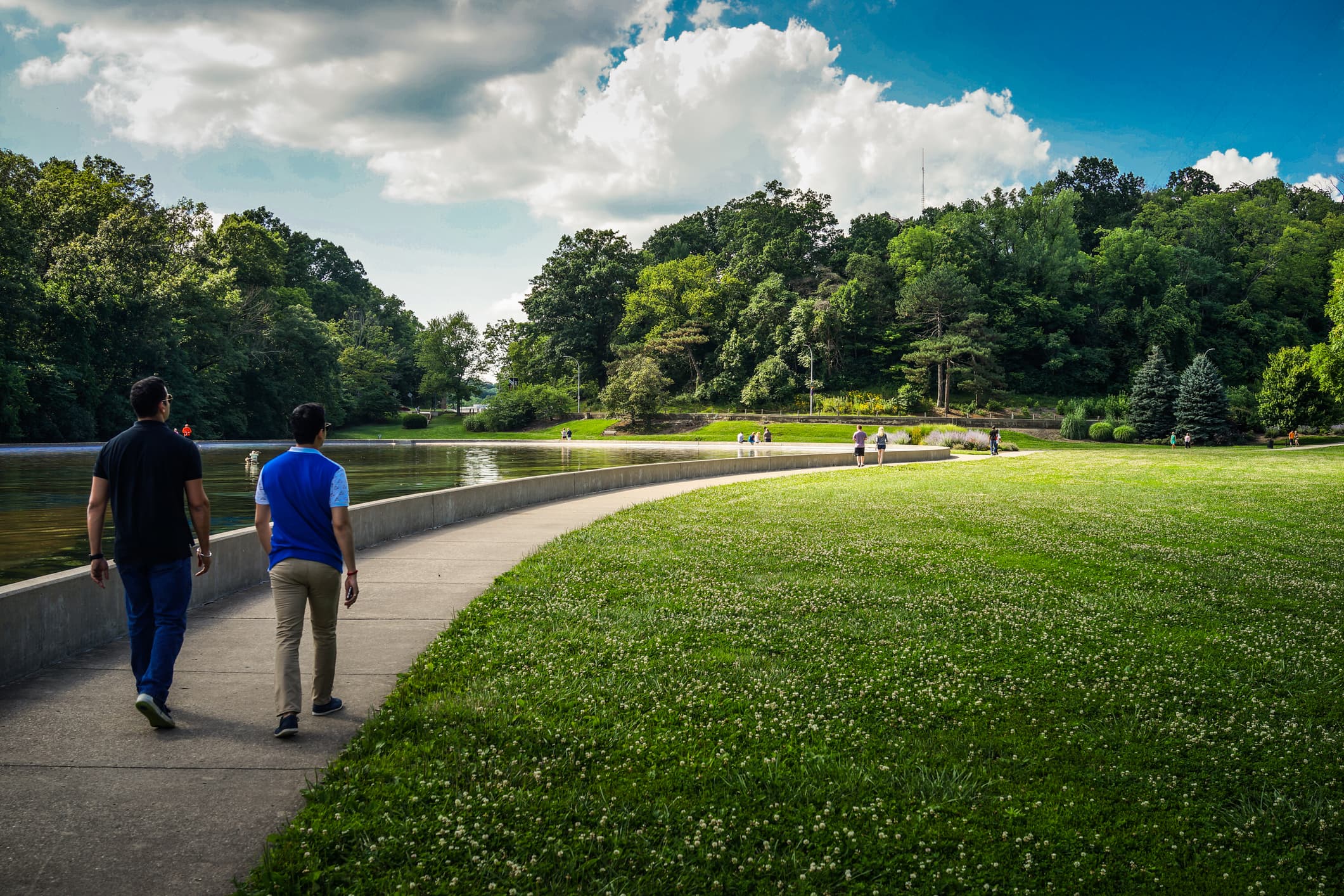 Two men walking through park