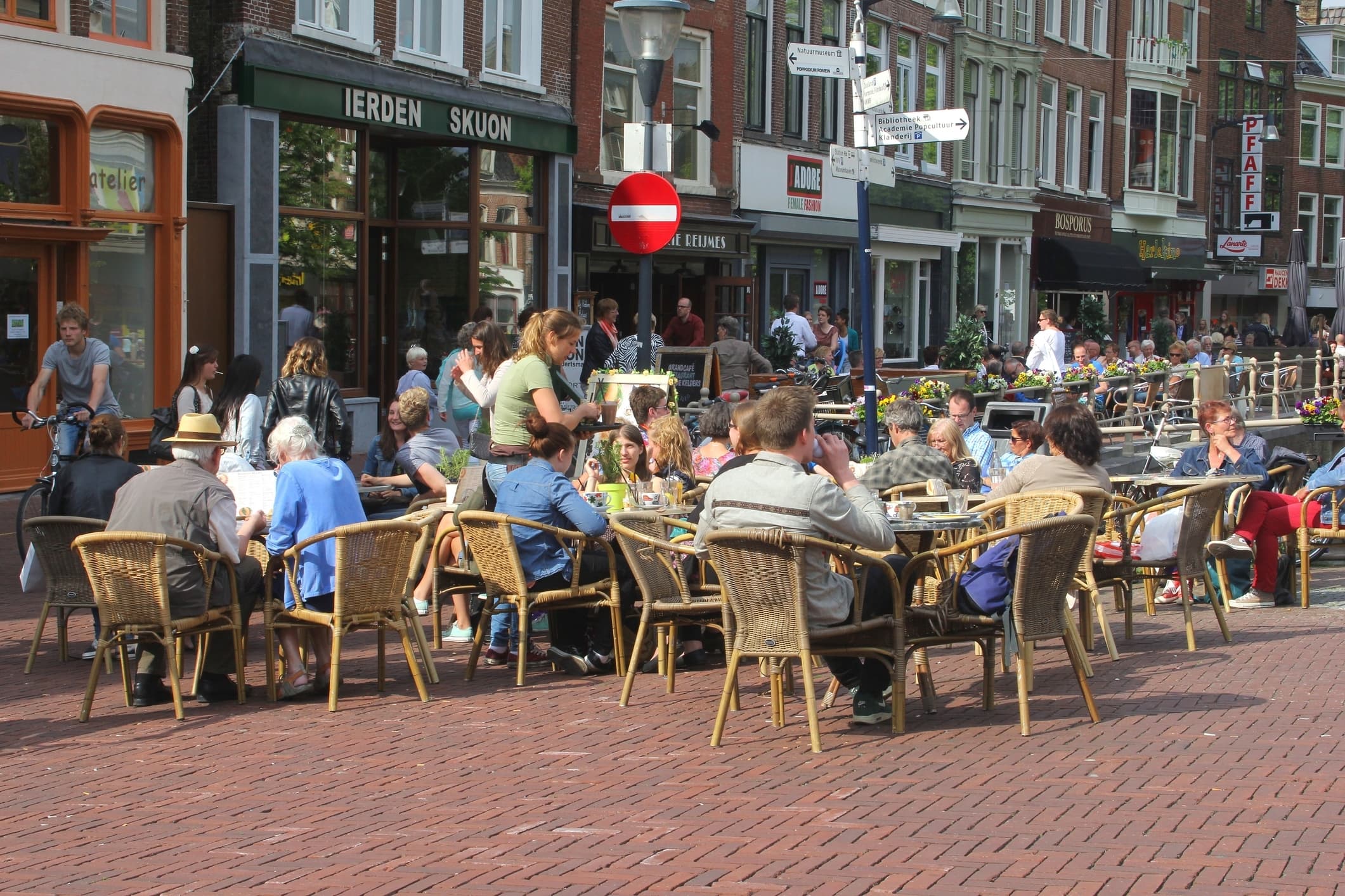 A street scene with people at cafe tables in Friesland, Netherlands