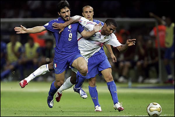 France's Florent Malouda (in white) is brought down by an Italian rival in the 2006 World Cup final, which Italy won