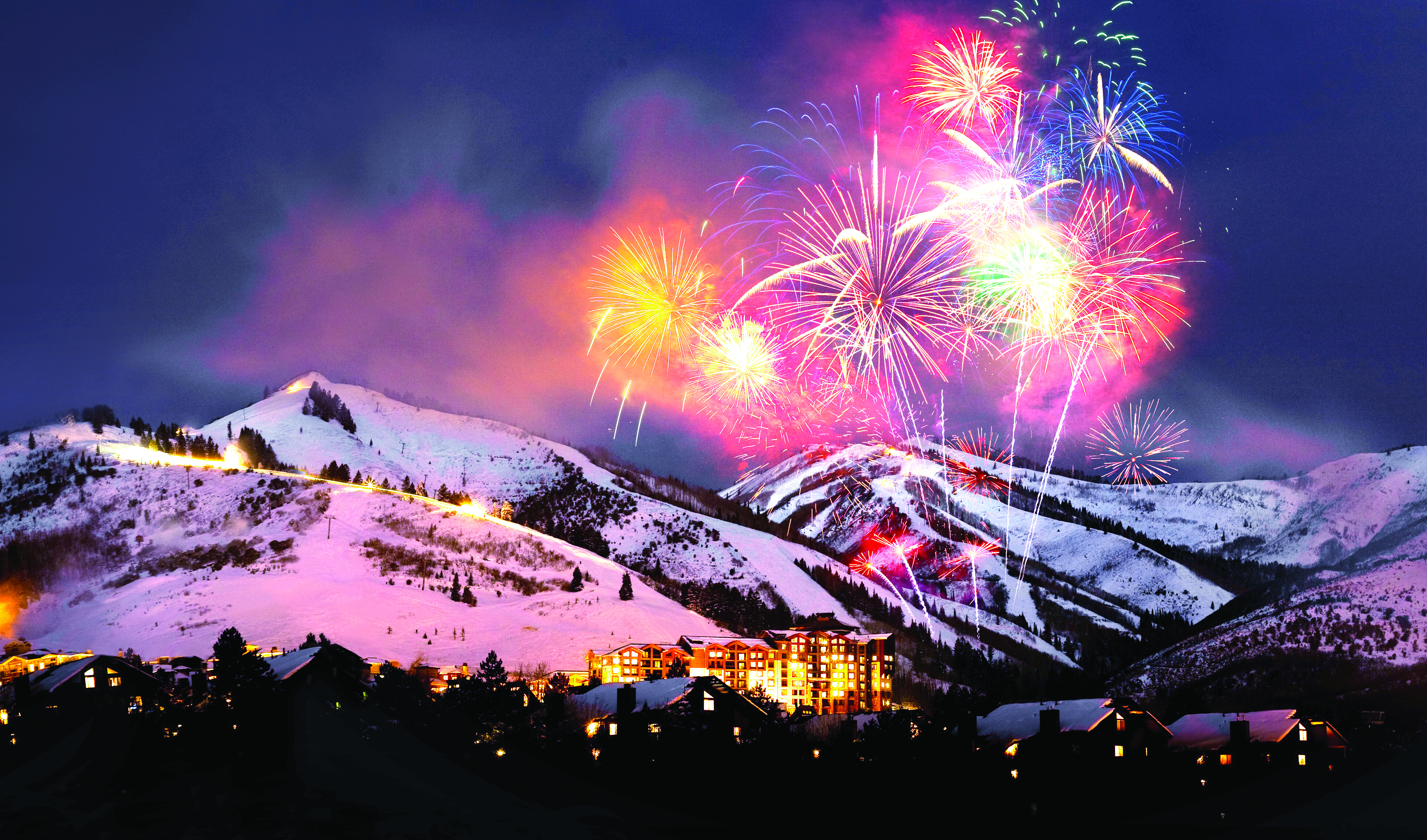 fireworks over town in mountains