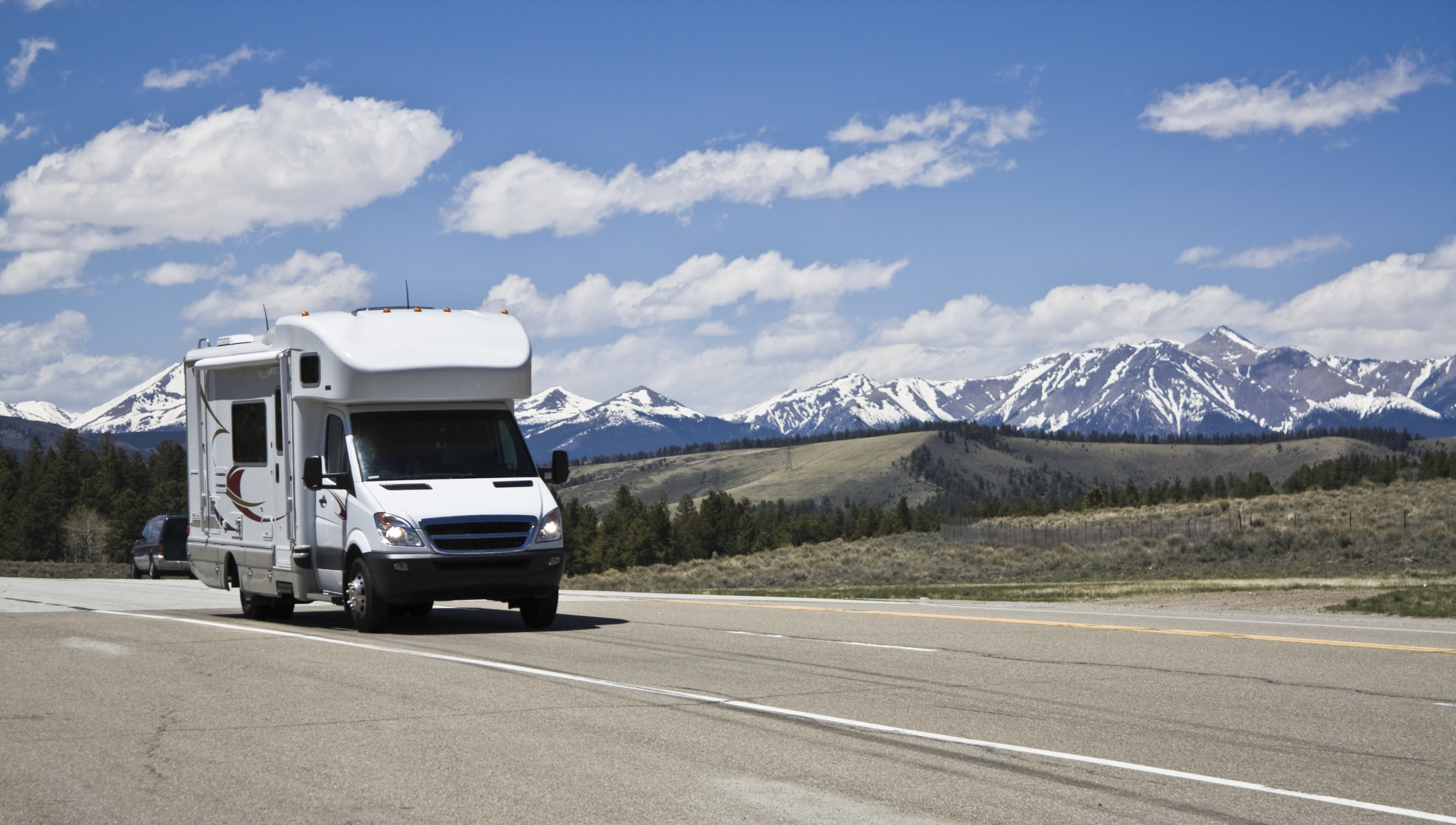 View of a highway in the Colorado Rockies with an RV.