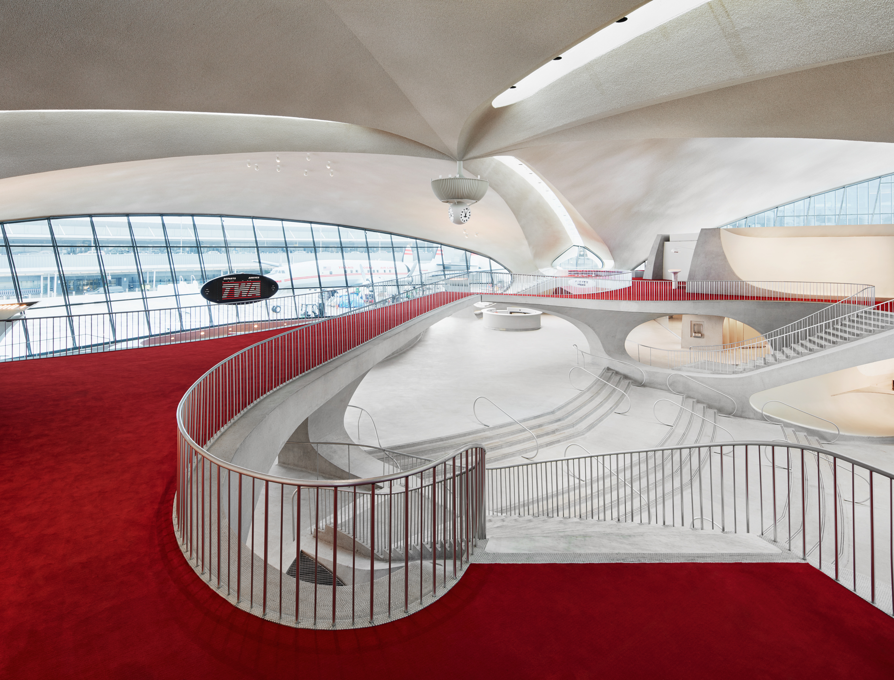 View of the white and red interior of the TWA Hotel at JFK airport