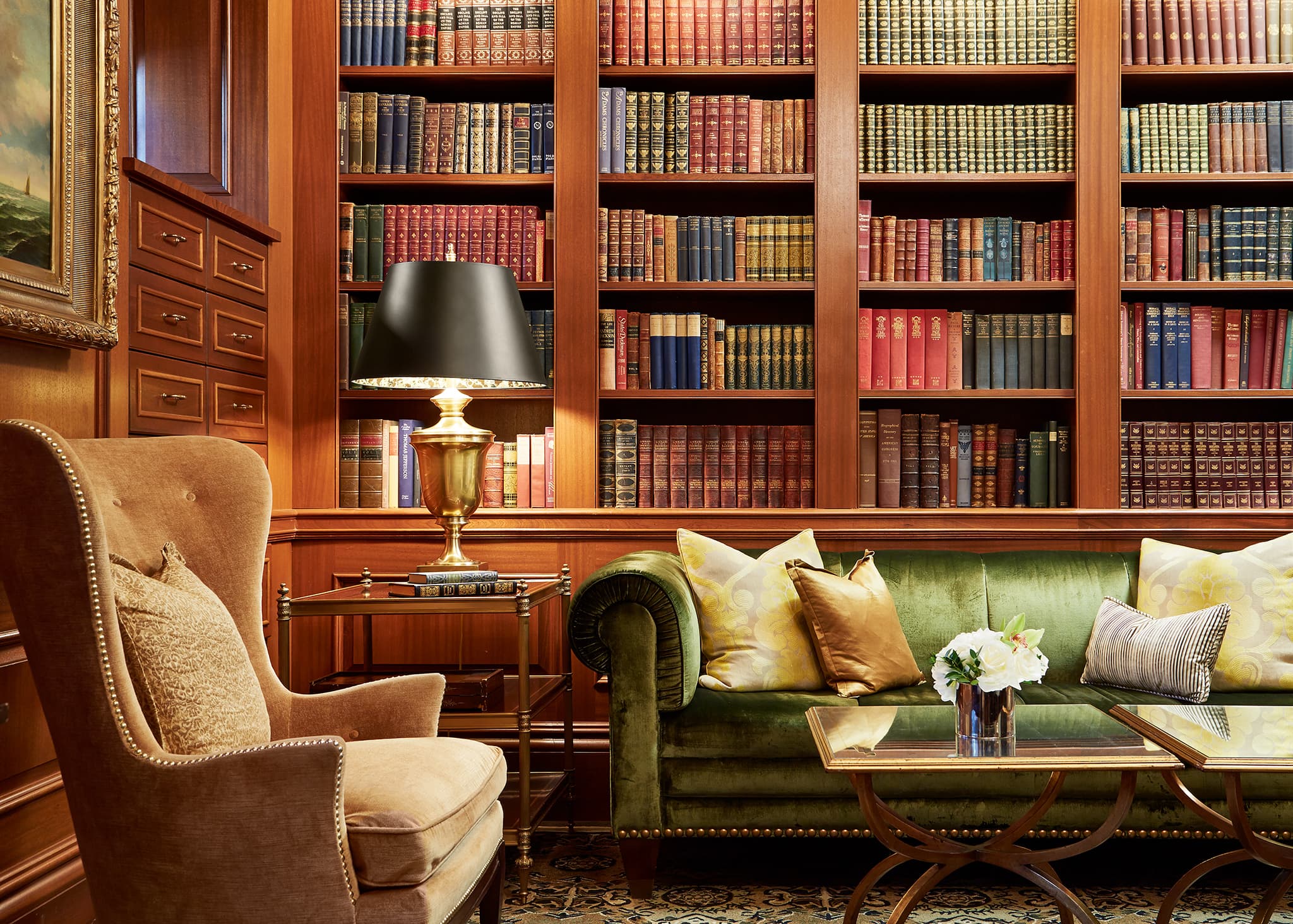 A view of a comfortable chair, sofa, and library shelves at the Jefferson DC Book Room.