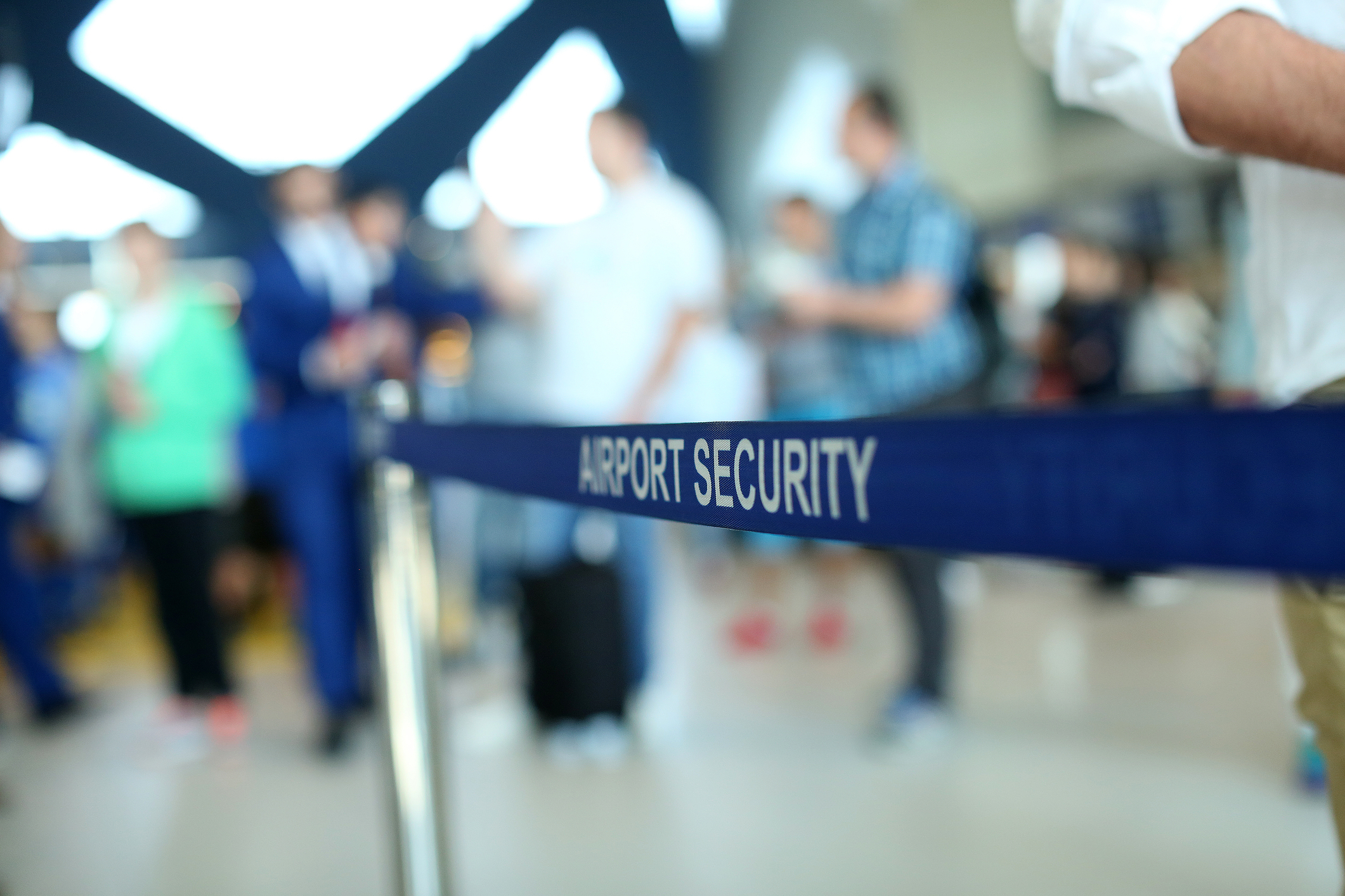 A sign reads "airport security" at an airport.
