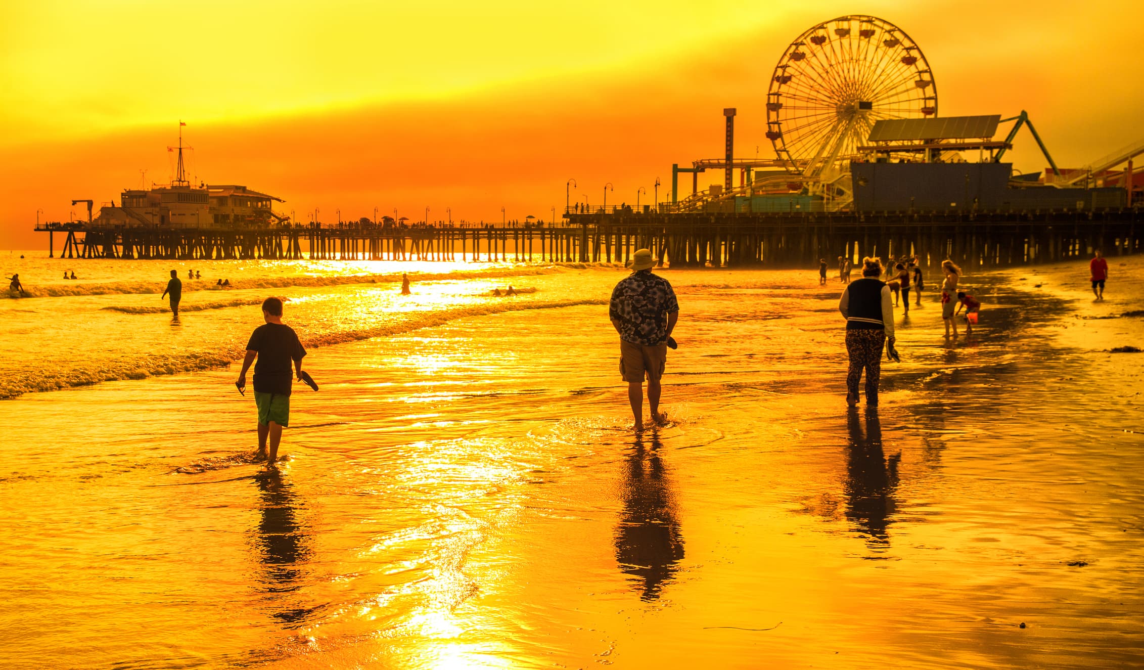 View of the sun setting behind Santa Monica beach and pier